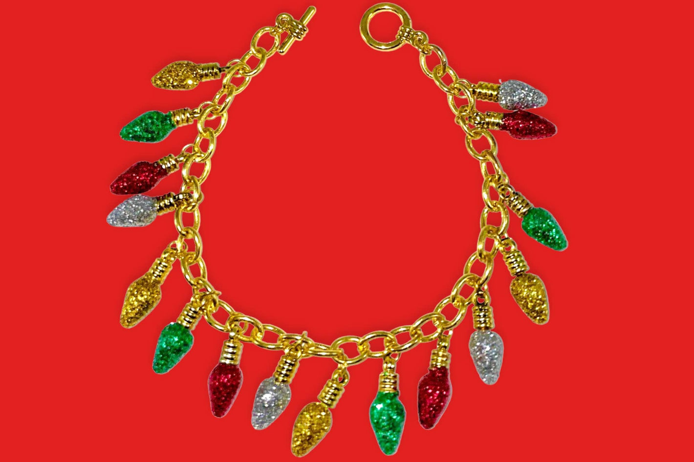 dainty gold christmas bracelet with red, green yellow and white glitter covered christmas light bulb charms